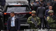 Ecuador's President Guillermo Lasso is surrounded by security as he enters a vehicle to leave the Metropolitan Cultural Center, located next to the presidential palace in Quito, Ecuador, Thursday, March 30, 2023. Ecuador's Constitutional Court ruled Wednesday the opposition-dominated National Assembly can take up the question of whether to impeach Lasso over allegations of crimes against state security and corruption. (AP Photo/Dolores Ochoa)