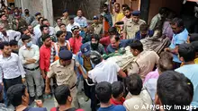 Rescue and security personnel carry a devotee on a stretcher who was injured after the floor covering a stepwell collapsed at a temple in Indore on March 30, 2023. - At least 13 devotees were killed and more than a dozen rescued on March 30 after they fell into a well at a Hindu temple in India, officials said. (Photo by AFP) (Photo by -/AFP via Getty Images)