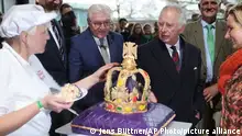 30.03.2023
King Charles III of Great Britain, right, looks at a cake made especially for his visit in the Brodowin eco-village Germany, Thursday, March 30, 2023. A heavy thunderstorm with lightning and thunder upset the strict protocol of the royal visit to the in Brandenburg. (Jens Buettner/DPA via AP, Pool)