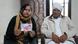Neelam Rani sits next to her elderly father holding a wedding photograph 
