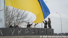 31.03.2023 *** Members of the Honour Guard attend a rising ceremony of the Ukraine's national flag during a ceremony to mark the first anniversary of liberation the town of Bucha, as Russia's invasion of Ukraine continues, outside Kyiv, Ukraine March 31, 2023. REUTERS/Gleb Garanich