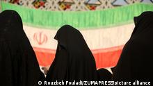 December 29, 2022, Tehran, Tehran, Iran: three veiled women stand in front of the Iranian flag during the Dey 9 anniversary rally at Imam Hossein Square in downtown Tehran, Iran, on December 29, 2022. On 30 December 2009, pro-government rallies, also known as the Dey 9 epic, took place in various Iranian cities, including Tehran, Shiraz, Arak, Qom and Isfahan. The rallies were hold in response to the Ashura protests, where protesters on that day did acts including applauding, whistling, and engaging in other cheerful displays, which was viewed as violation of a red line and targeting Husayn ibn Ali and Ashura commemoration itself. The demonstrations and counter-demonstrations were connected to the disputed 2009 Iranian presidential election. (Credit Image: Â© Rouzbeh Fouladi via ZUMA Press Wire