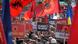 People holding up banners and flags at a protest rally People holding up banners and flags at a protest rally