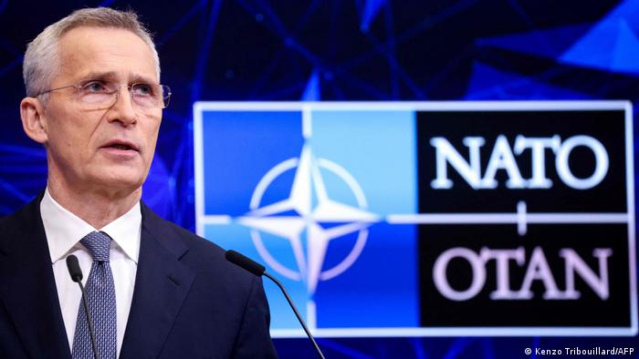 NATO Secretary General Jens Stoltenberg in front of the NATO symbol