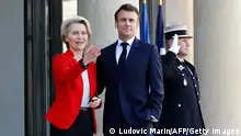 French President Emmanuel Macron (R) welcomes European Commission President Ursula von der Leyen prior to a meeting at the Elysee Palace in Paris on April 3, 2023. (Photo by Ludovic MARIN / AFP) (Photo by LUDOVIC MARIN/AFP/Getty Images)
