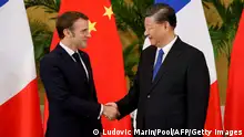 French President Emmanuel Macron (L) shakes hands with Chinese President Xi Jinping prior to their meeting in Nusa Dua, on the Indonesian resort island of Bali on November 15, 2022 on the sidelines of the G20 Summit. (Photo by Ludovic MARIN / POOL / AFP) (Photo by LUDOVIC MARIN/POOL/AFP via Getty Images)