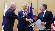 Finnish Foreign Minister Pekka Haavisto shakes hands with U.S. Secretary of State Antony Blinken as NATO Secretary-General Jens Stoltenberg claps during a joining ceremony at the NATO foreign ministers' meeting at the Alliance's headquarters in Brussels, Belgium April 4, 2023. REUTERS/Johanna Geron/Pool