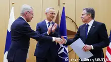 Finnish Foreign Minister Pekka Haavisto shakes hands with U.S. Secretary of State Antony Blinken as NATO Secretary-General Jens Stoltenberg claps during a joining ceremony at the NATO foreign ministers' meeting at the Alliance's headquarters in Brussels, Belgium April 4, 2023. REUTERS/Johanna Geron/Pool