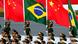 A Chinese military honor guard holds the national flags of China and Brazil A Chinese military honor guard holds the national flags of China and Brazil