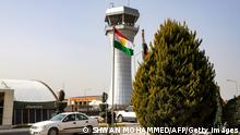 This picture taken on January 26, 2019 shows journalists filming outside the departure lounge and control tower of Sulaymaniyah International Airport as its director announced the resumption of flights between the city and Turkey after a 16-month air blockade imposed by Ankara over a referendum on Iraqi Kurdish independence in September 2017. - Kurds in the administratively autonomous northern region overwhelmingly then voted for independence in a non-binding referendum that infuriated Baghdad as well as Iraq's neighbours, Turkey and Iran. (Photo by Shwan MOHAMMED / AFP) (Photo credit should read SHWAN MOHAMMED/AFP via Getty Images)