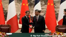 French President Emmanuel Macron, left, shakes hands with Chinese President Xi Jinping after meeting the press at the Great Hall of the People in Beijing, Thursday, April 6, 2023. (AP Photo/Ng Han Guan, Pool)