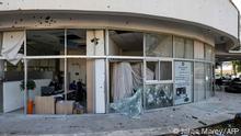 This picture taken on April 6, 2023 shows a view of the damaged glass facade of a building in the aftermath of intercepted rocket fire launched from Lebanon and intercepted by Israel in its northern town of Shlomi. - The Israeli army said it intercepted rocket fire from Lebanon on April 6 after clashes between Israeli police and Palestinians inside Islam's third-holiest site drew warnings of retaliation from around the region. (Photo by Jalaa MAREY / AFP)