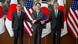 Funakoshi Takehiro, Kim Gunn and Sung Kim shaking hands in front of flags Funakoshi Takehiro, Kim Gunn and Sung Kim shaking hands in front of flags