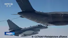In this image taken from video footage run Saturday, April 8, 2023 by China's CCTV, a Chinese fighter jet performs an mid-air refueling maneuver at an unspecified location. The Chinese military announced exercises around Taiwan on Saturday in a new act of retaliation for a meeting between the U.S. House of Representatives speaker and the president of the self-ruled island democracy claimed by Beijing as part of its territory. (CCTV via AP)