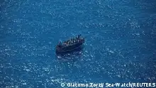 The boat in distress with about 400 people on board is pictured in Central Mediterranean Sea in this handout obtained by Reuters on April 10, 2023. Giacomo Zorzi/ Sea-Watch/Handout via REUTERS THIS IMAGE HAS BEEN SUPPLIED BY A THIRD PARTY. NO RESALES. NO ARCHIVES. MANDATORY CREDIT.