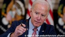 President Joe Biden adjusts his microphone during a meeting with the President's Council of Advisors on Science and Technology in the State Dining Room of the White House, Tuesday, April 4, 2023, in Washington. (AP Photo/Patrick Semansky)