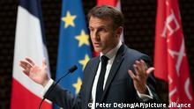 French President Emmanuel Macron explains his vision on the future of Europe during a lecture in a theatre in The Hague, Netherlands, Tuesday, April 11, 2023. (AP Photo/Peter Dejong)