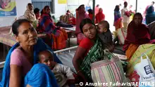 Patients wait outside a primary health care centre in Belwa village, Kishanganj district, Bihar, India, March 20, 2023. India's fertility rate, fell to 2.0 in 2019-21, but State health officials estimate Kishanganj's fertility rate at 4.8 or 4.9, creating a population growth problem that the state is trying to curb with the distribution of condoms and birth control pills, as well as the paying 3,000 Indian rupees ($36.50) to women who get sterilised, 4,000 rupees to men, and 500 rupees per surgery to the health workers who perform them. The state government's focus is to ensure that policy interventions percolate to the ground, its mechanisms such as free sterilisation, temporary birth control instruments are used actively, said Sanjay Kumar Pansari, director in the Bihar government's Directorate of Economics and Statistics. REUTERS/Anushree Fadnavis SEARCH FADNAVIS POPULATION FOR THIS STORY. SEARCH WIDER IMAGE FOR ALL STORIES.