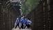 Young people wearing the Israeli flag over their shoulders while they walk through the former Auschwitz concentration camp in Poland. Young people wearing the Israeli flag over their shoulders while they walk through the former Auschwitz concentration camp in Poland.