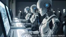 Generative AI image of group of robots sitting at table and working on laptops while looking at screen in modern office and using artificial intelligence ManuelRuiz_ID13614_413581_011 Copyright: xManuelxRuizx