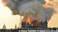 ARCHIVC 2019 *** In this image made available on Tuesday April 16, 2019 flames and smoke rise from the blaze at Notre Dame cathedral in Paris, Monday, April 15, 2019. An inferno that raged through Notre Dame Cathedral for more than 12 hours destroyed its spire and its roof but spared its twin medieval bell towers, and a frantic rescue effort saved the monument's most precious treasures, including the Crown of Thorns purportedly worn by Jesus, officials said Tuesday. (AP Photo/Thierry Mallet)