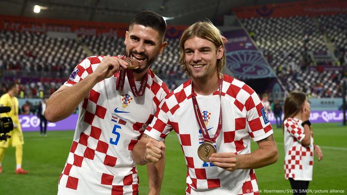 Croatia's players Martin Erlic and Borna Sosa with medals for winning the third place match after the awards ceremony