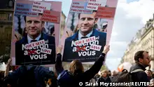 FILE PHOTO: Protesters hold placards depicting French President Emmanuel Macron during a demonstration as part of the 12th day of nationwide strikes and protests against French government's pension reform, in Paris, France, April 13, 2023. REUTERS/Sarah Meyssonnier/File Photo