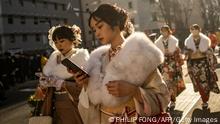 09/01/2023**Young women wear kimonos to mark Coming of Age Day to honour people who turn 20 this year to signify adulthood, in Yokohama, Kanagawa prefecture on January 9, 2023. (Photo by Philip FONG / AFP) (Photo by PHILIP FONG/AFP via Getty Images)
