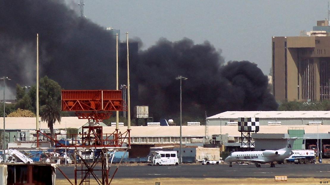 Heavy smoke bellows above buildings in the vicinity of the Khartoum airport on April 15, 2023
