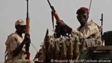 Sudanese soldiers from the Rapid Support Forces unit which led by Gen. Mohammed Hamdan Dagalo, the deputy head of the military council, secure the area where Dagalo attends a military-backed tribe's rally, in the East Nile province, Sudan, Saturday, June 22, 2019. Sudan's protest leaders say they are meeting with an Ethiopian envoy over proposals to resume negotiations with the ruling military council. (AP Photo/Hussein Malla)