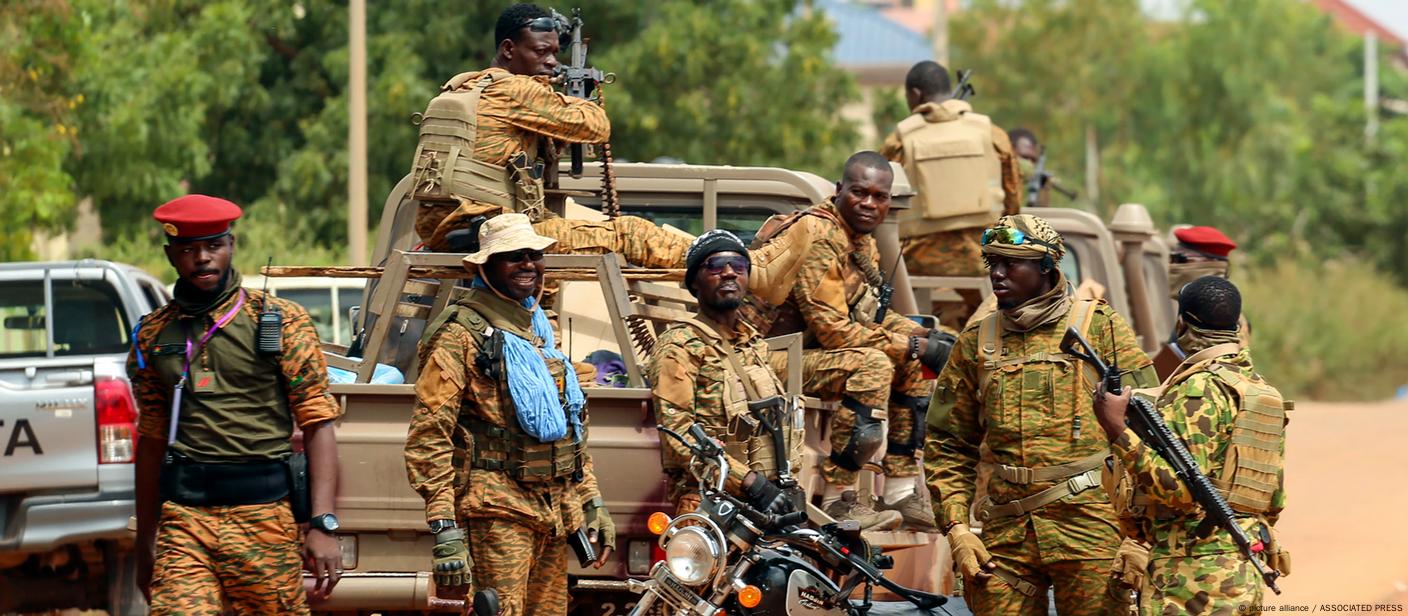 Several soliders on a vehicle