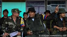 FARC-EP dissidence comander Calarca (C) speaks with top comander Ivan Mordisco (L) during a meeting with local communities in San Vicente del Caguan, Caqueta department, Colombia on April 16, 2023. - An armed dissident group of Colombia's disbanded FARC guerrillas said Sunday it was ready to start peace talks with the government from May 16. We are announcing to the world that our delegates to the dialogue table with the Colombian government... are ready for May 16, the EMC dissident grouping, which rejected a 2016 peace deal that disarmed the FARC, said through a spokesperson. (Photo by JOAQUIN SARMIENTO / AFP)