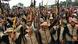 FARC dissidents hold batons in the air at a meeting with local communities FARC dissidents hold batons in the air at a meeting with local communities