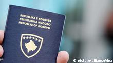 A Kosovar Albanian man shows his newly issued Kosovo passport in Kosovo's capital Pristina, 30 July 2008. New Kosovo Passports were issued after Kosovo has declared independence from Serbia on 17 February 2008. EPA/VALDRIN XHEMAJ +++(c) dpa - Bildfunk+++
