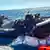 Italian Financial Police in a boat seize sacks of cocaine in the sea off Sicily
