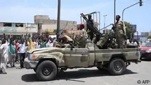 Sudanese greet army soldiers, loyal to army chief Abdel Fattah al-Burhan, in the Red Sea city of Port Sudan on April 16, 2023. - Battling fighters in Sudan said they had agreed to an hours-long humanitarian pause, including to evacuate wounded, on the second day of raging urban battles that killed more than 50 civilians including three UN staff and sparking international outcry. (Photo by AFP)