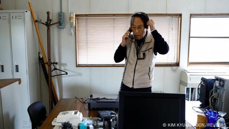 Shingo Shiozawa on the phone of his office