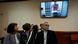 Mother Tatyana, left, and father Valery, right, of Russian opposition activist Ilya Yashin look at a TV screen, as Yashin appears in a video link provided by the Russian Federal Penitentiary Service in a courtroom of the Moscow City Court