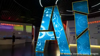 The letters AI are seen at a trade fair pavilion in China