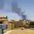Smoke billowing over the rooftops of Khartoum