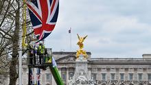Workers hang a Union Jack flag along The Mall, leading to Buckingham Palace, in London, on April 18, 2023 ahead of the London Marathon of April 23, 2023 . (Photo by JUSTIN TALLIS / AFP) (Photo by JUSTIN TALLIS/AFP via Getty Images)