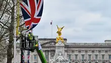 Workers hang a Union Jack flag along The Mall, leading to Buckingham Palace, in London, on April 18, 2023 ahead of the London Marathon of April 23, 2023 . (Photo by JUSTIN TALLIS / AFP) (Photo by JUSTIN TALLIS/AFP via Getty Images)