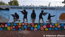 FILE - A mural is seen in Ouagadougou, Burkina Faso, on March 1, 2023. Burkina Faso's government has opened investigations into allegations of human rights abuses by its security forces after a video surfaced that appeared to show the extrajudicial killing of seven children in the countryâ€™s north. A government spokesman said Thursday April 20, 2023 that â€œthe conclusions of the said investigations will lead, if the facts are established, to legal proceedings against the persons responsible.â€ (AP Photo, File)