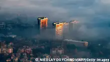 A picture taken from Vitosha mountain on November 27, 2020, shows buildings above clouds in an area with a high level of air pollution in Sofia, Bulgaria. - Winter smog season has settled in and Bulgaria's soaring coronavirus death rate, one of Europe's highest, is prompting experts to warn about a compound health risk from air pollution and Covid-19. (Photo by NIKOLAY DOYCHINOV / AFP) (Photo by NIKOLAY DOYCHINOV/AFP via Getty Images)
