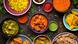 Assorted Indian food on dark wooden background.