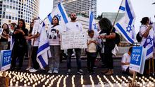 25.04.2023 *** Boaz Zirkel, cofounder of Bereaved families for Democracy holds a sign commemorating his brother Yonatan as he attends a protest against Israel's nationalist coalition government's judicial overhaul in Tel Aviv, Israel, April 22, 2023. REUTERS/Corinna Kern