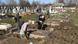 Workers dig at a burial site in Ukraine Workers dig at a burial site in Ukraine