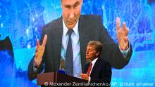17/12/2020 Kremlin spokesman Dmitry Peskov, bottom, looks on as Russian President Vladimir Putin speaks via video call during a news conference in Moscow, Russia, Thursday, Dec. 17, 2020. This year, Putin attended his annual news conference online due to the coronavirus pandemic. (AP Photo/Alexander Zemlianichenko)