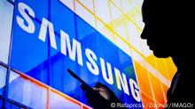 March, 30 2022, Brazil. In this photo illustration, a woman s silhouette holds a smartphone with the Samsung Electronics logo in the background. March, 30 2022, Brazil. In this photo illustration, a woman s silhouette holds a smartphone with the Samsung Electronics logo in the background Copyright: xZoonar.com/Rafapressx zoonar_18483424
