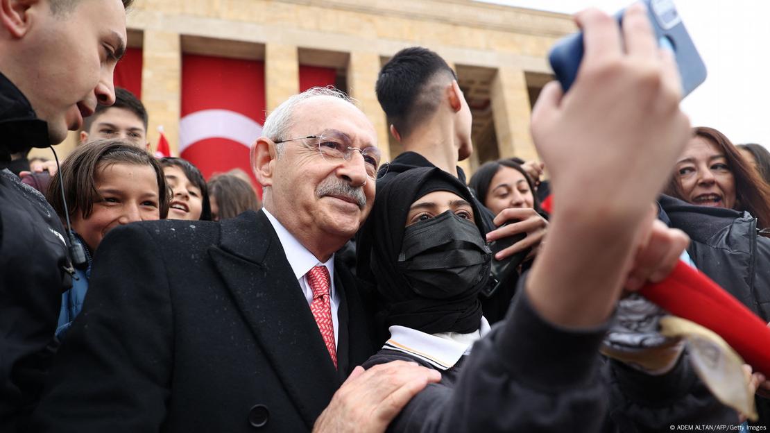 A veiled and masked woman takes a selfie with Kemal Kilicdaroglu